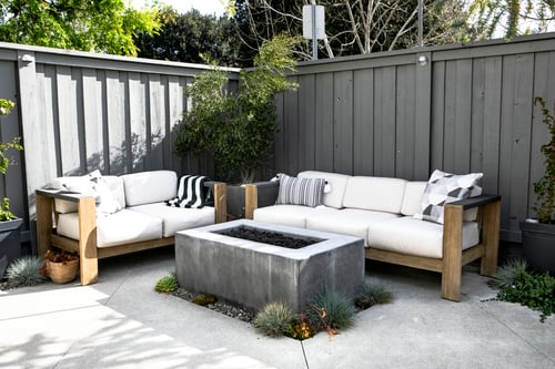 Finished concrete patio with outdoor seating and a fire table